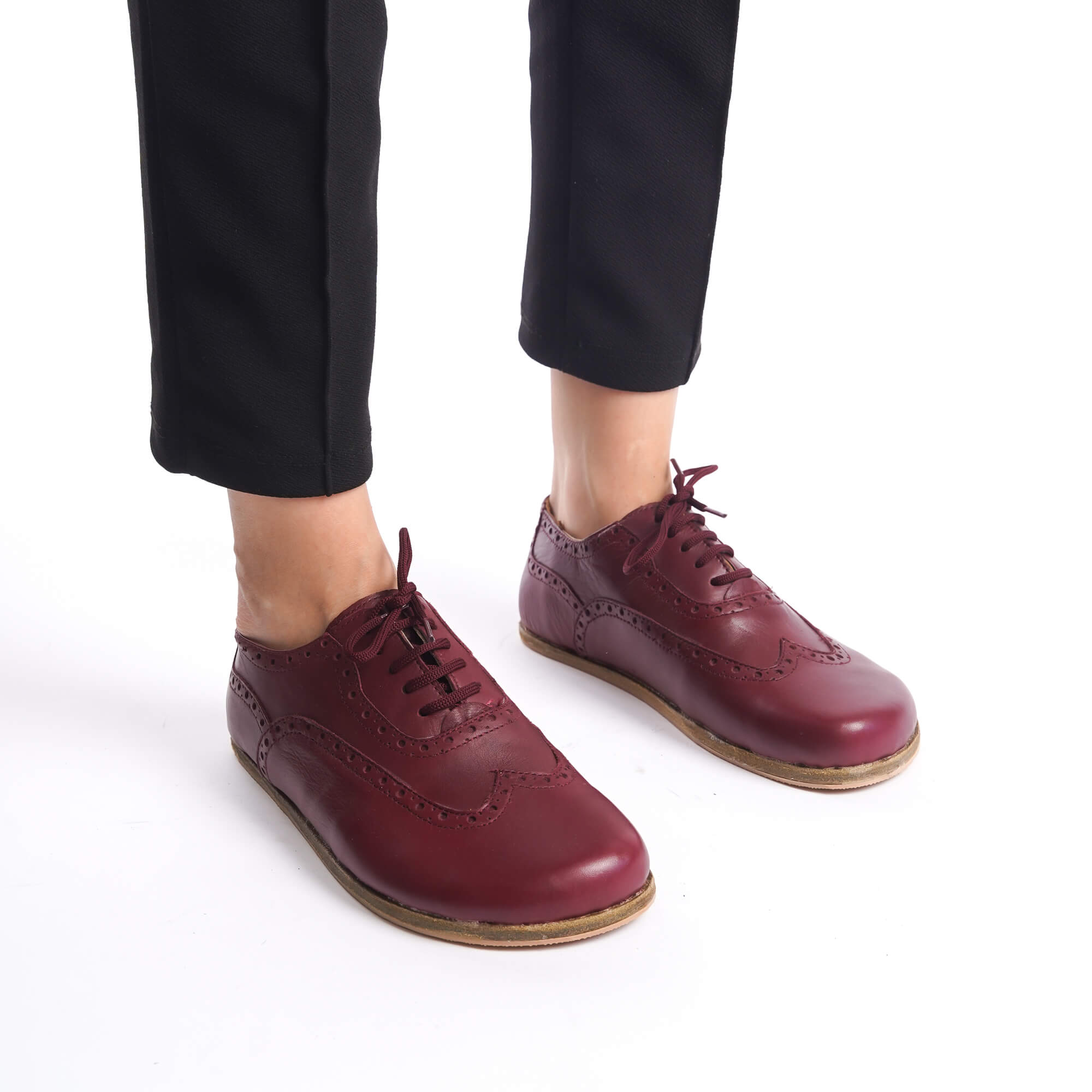 Front view of Burgundy Doris Leather Barefoot Women Oxfords worn by a model with black pants.
