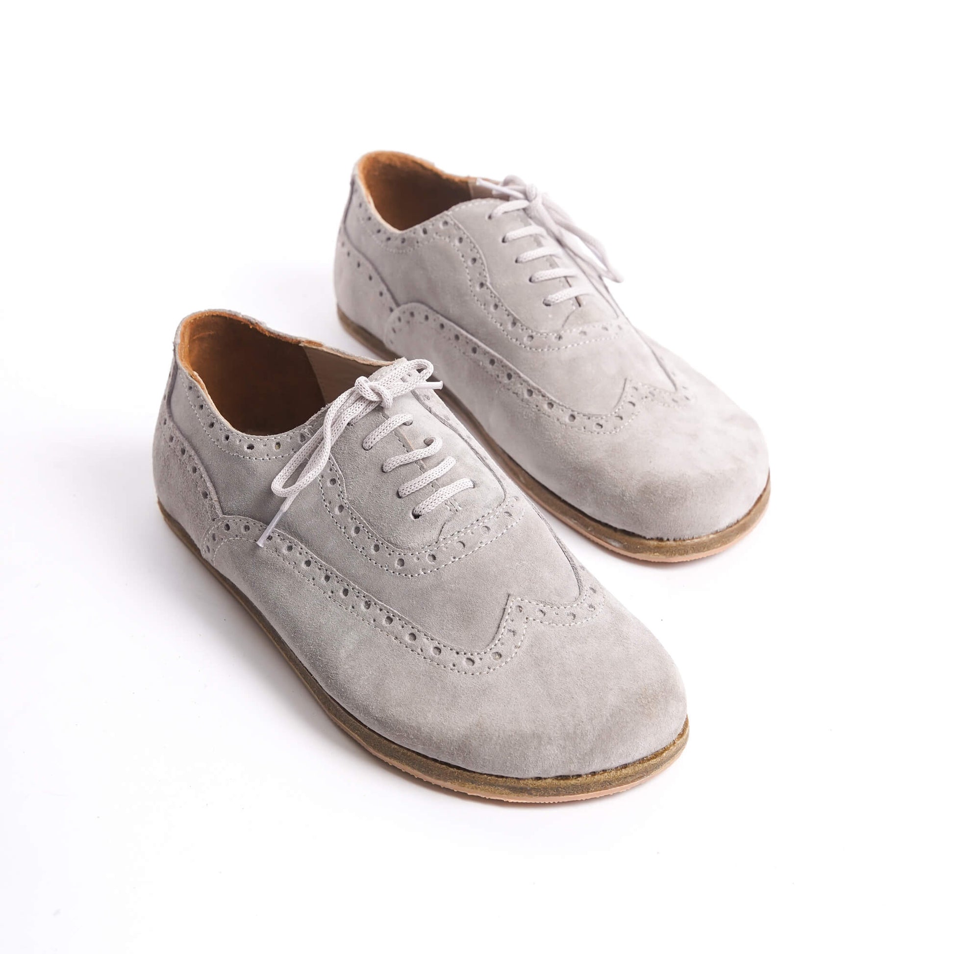 Close-up of gray Doris leather barefoot women's oxfords with lace-up design and intricate broguing details.