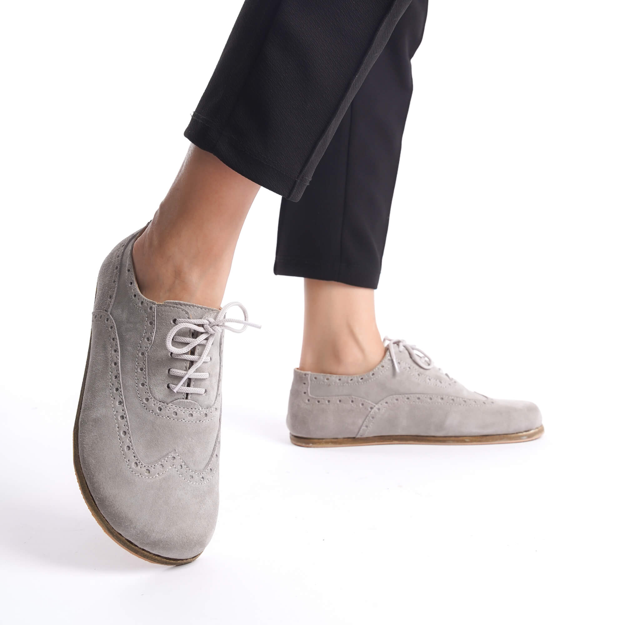 Model wearing gray Doris leather barefoot women Oxfords, showcasing the shoes' sleek and flexible design.