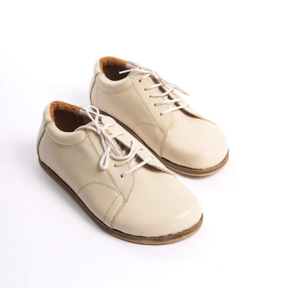 Beige leather barefoot women's sneakers showcasing detailed laces and natural materials for ultimate comfort and style.