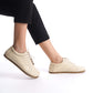 Model wearing beige leather barefoot women's sneakers, highlighting the sleek design and natural fit for everyday wear.