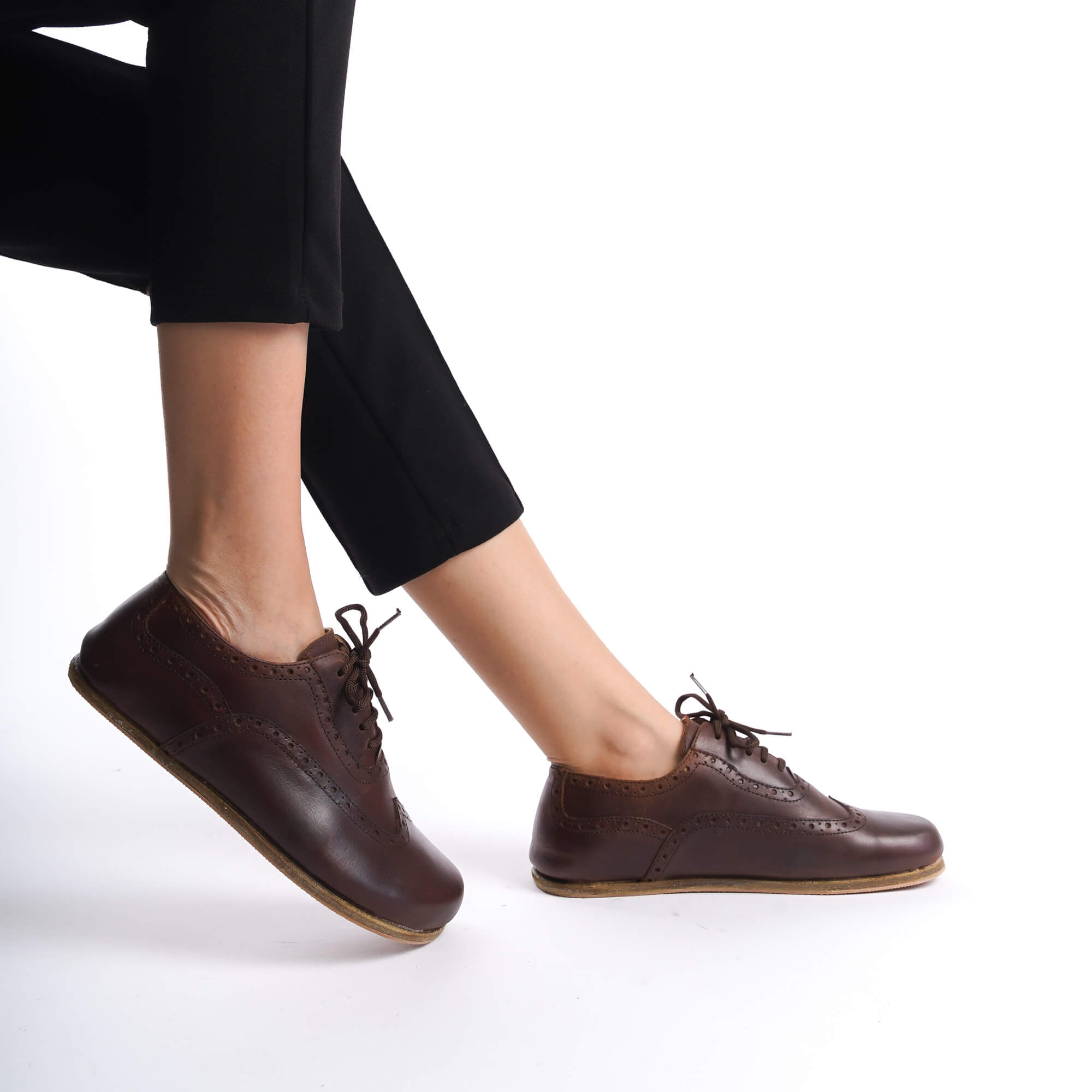 Side view of Doris brown leather barefoot women's oxford shoes, showing the intricate brogue patterns and minimalist barefoot sole.