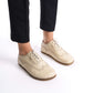 Woman's feet in beige Doris leather barefoot women's oxfords, highlighting their flexible sole and comfortable fit.