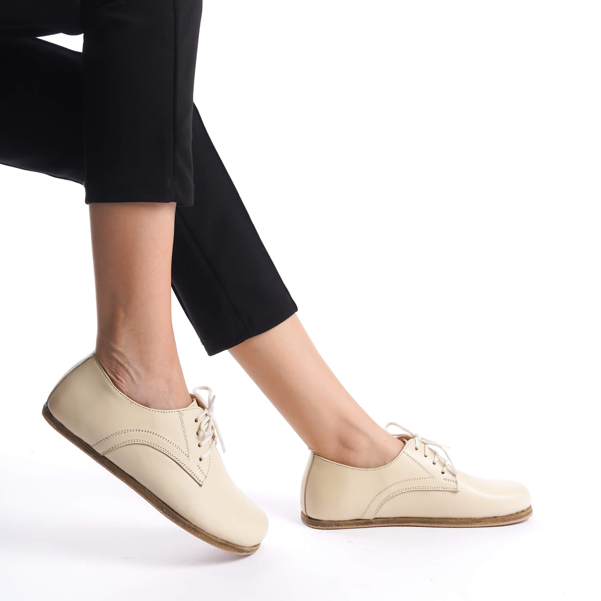 Close-up of beige Locris barefoot oxfords being worn, highlighting the comfort and fit.