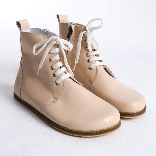 Stylish beige barefoot ankle boots with a sleek design and lace-up front, perfect for modern casual wear.