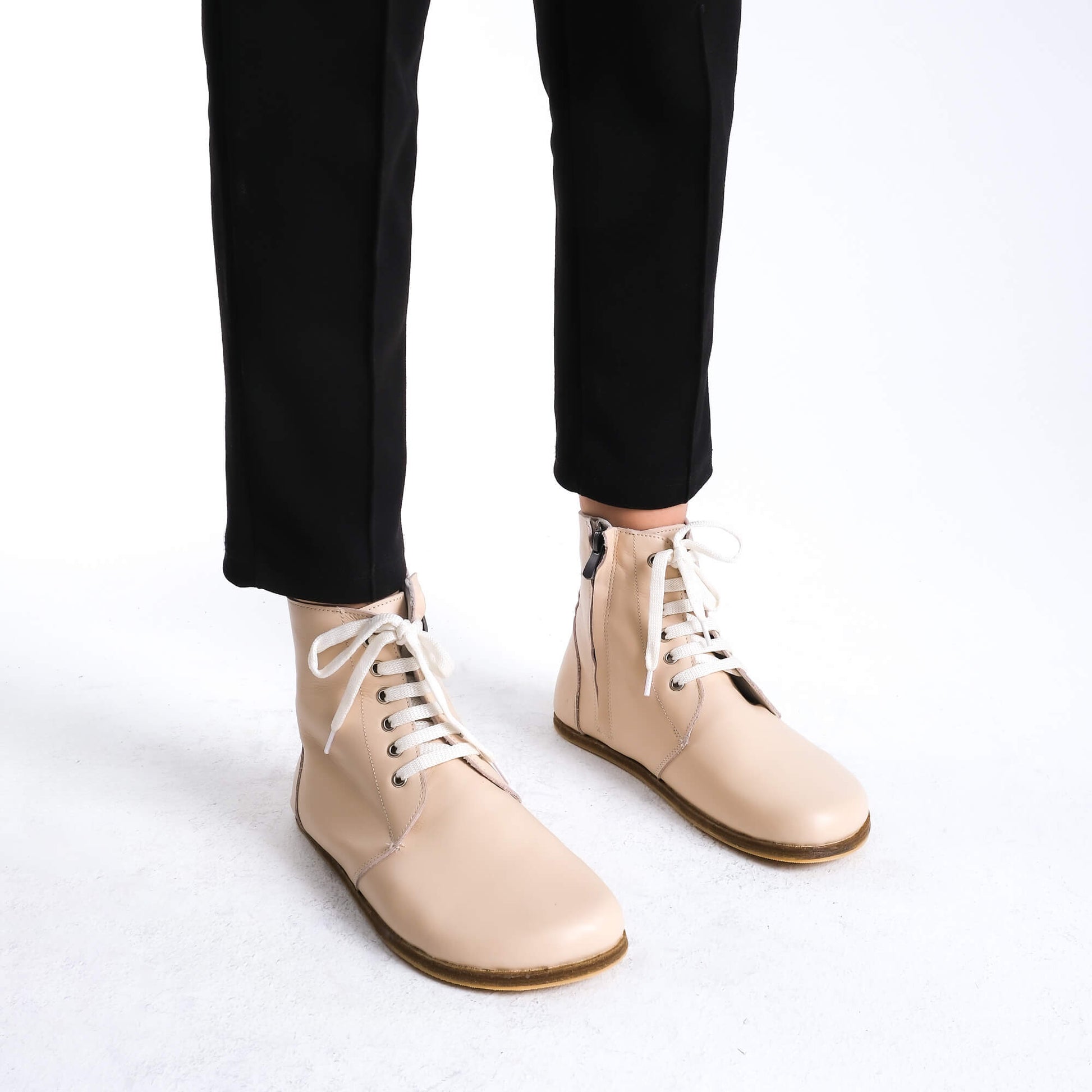 Premium beige leather barefoot boots showcasing a contemporary design for a polished look.