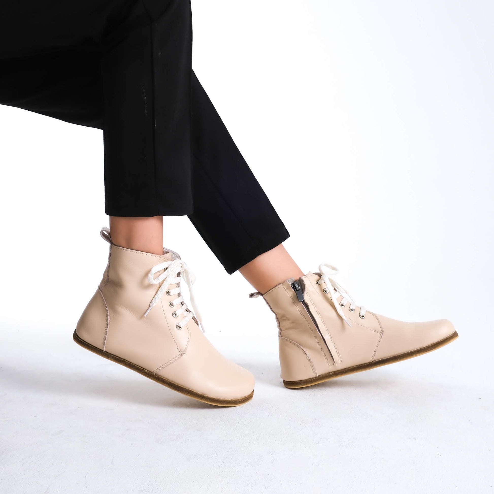 Chic beige barefoot boots featuring a minimalist style, designed for comfort and flexibility.