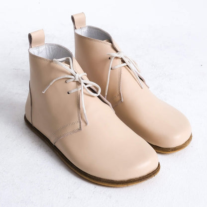 Stylish beige barefoot ankle boots with a minimalist design, perfect for comfort.