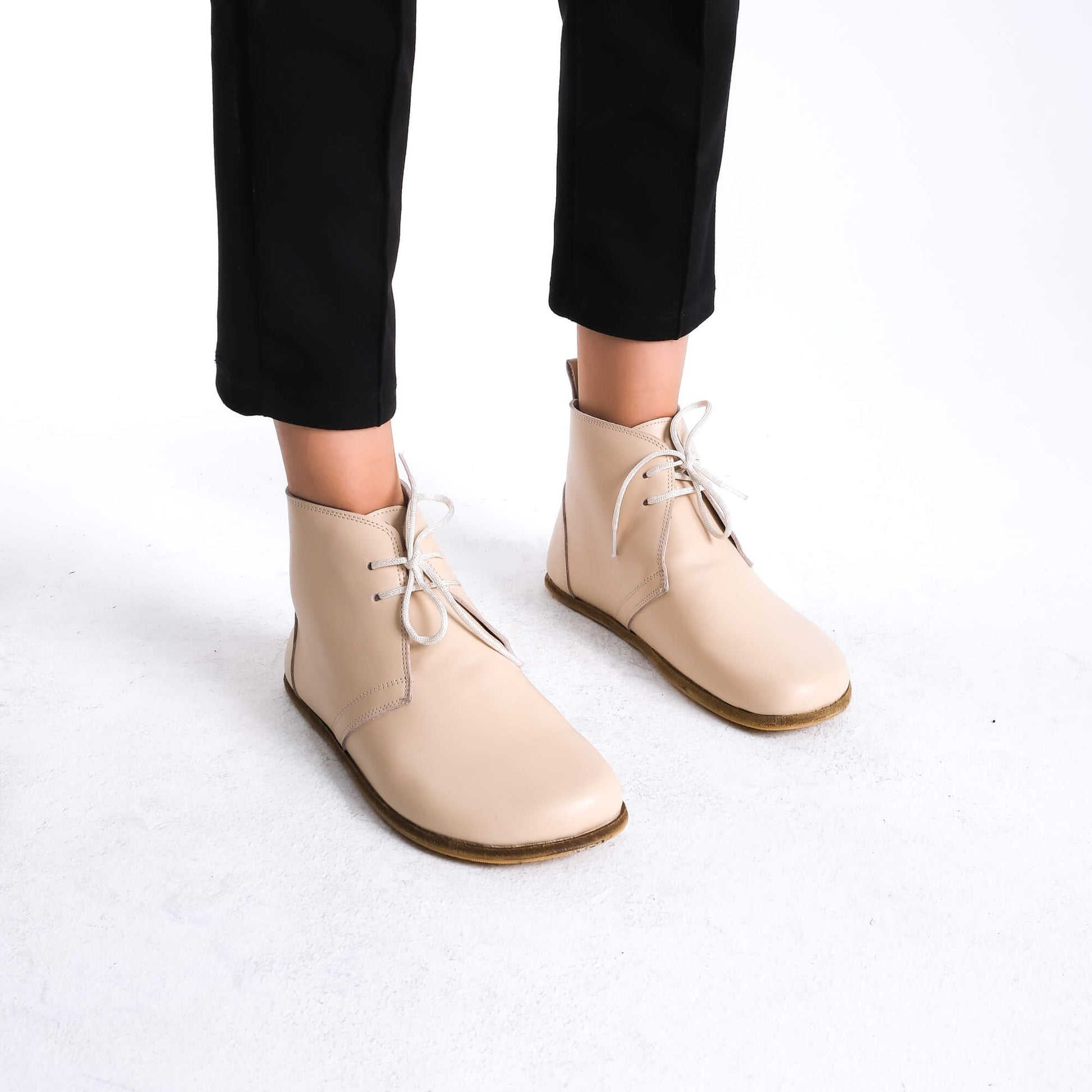 Premium beige barefoot boots showcasing a sleek design for a modern aesthetic.