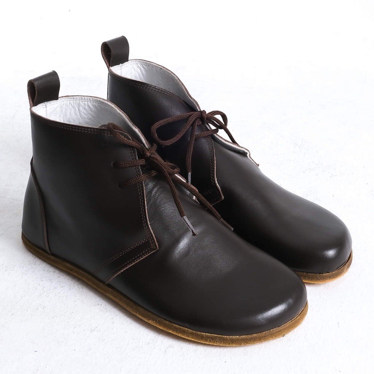 Stylish brown barefoot ankle boots with a minimalist design, perfect for comfort.