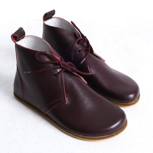 Stylish burgundy barefoot ankle boots with a minimalist design, perfect for comfort.