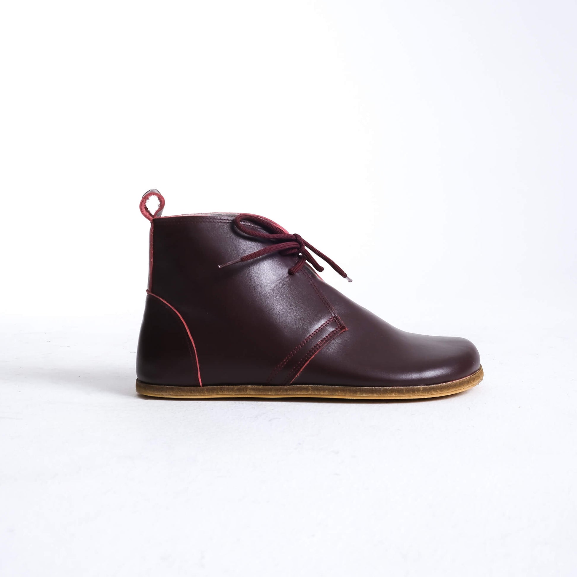 Trendy burgundy barefoot boots featuring a unique design for ultimate comfort.