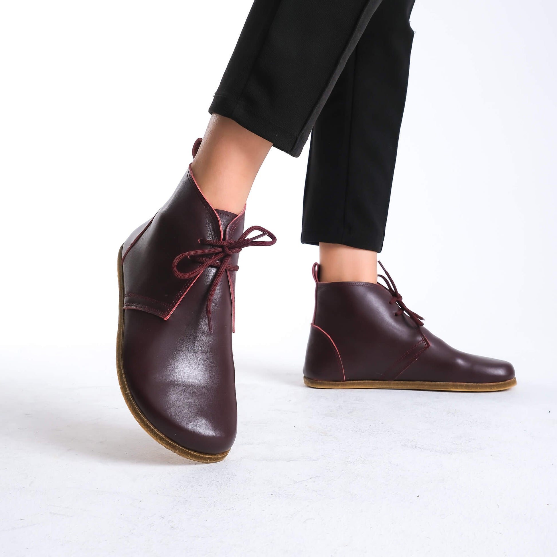 Versatile burgundy barefoot ankle boots, blending style and comfort effortlessly.