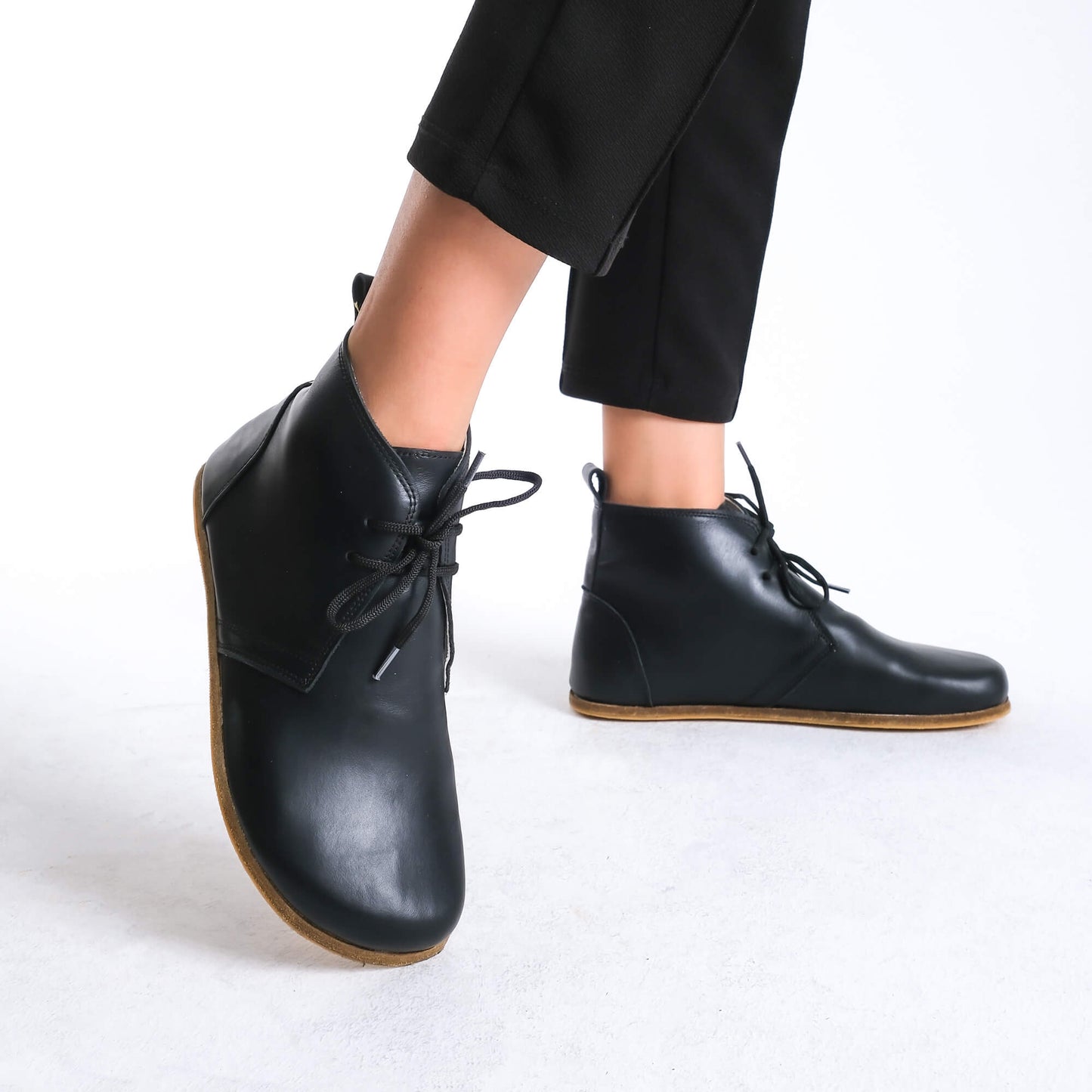 Versatile black barefoot ankle boots, blending style and comfort effortlessly.