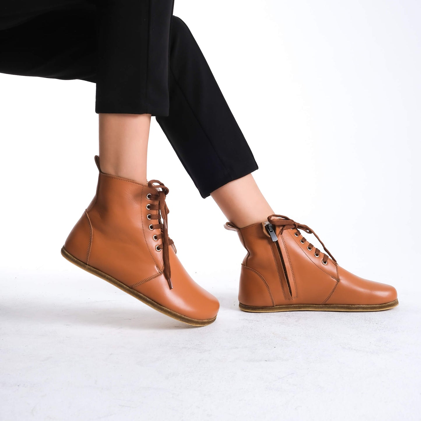 Durable tan brown barefoot ankle boots with lace details, ideal for both everyday and active use.