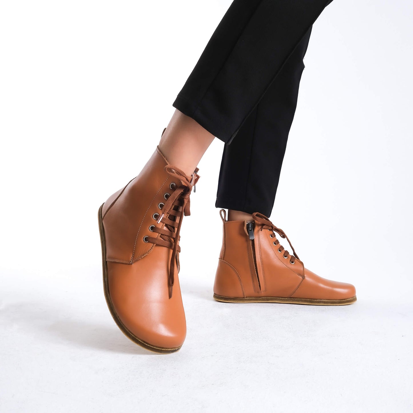 Chic tan brown barefoot boots featuring a minimalist style, designed for comfort and flexibility.