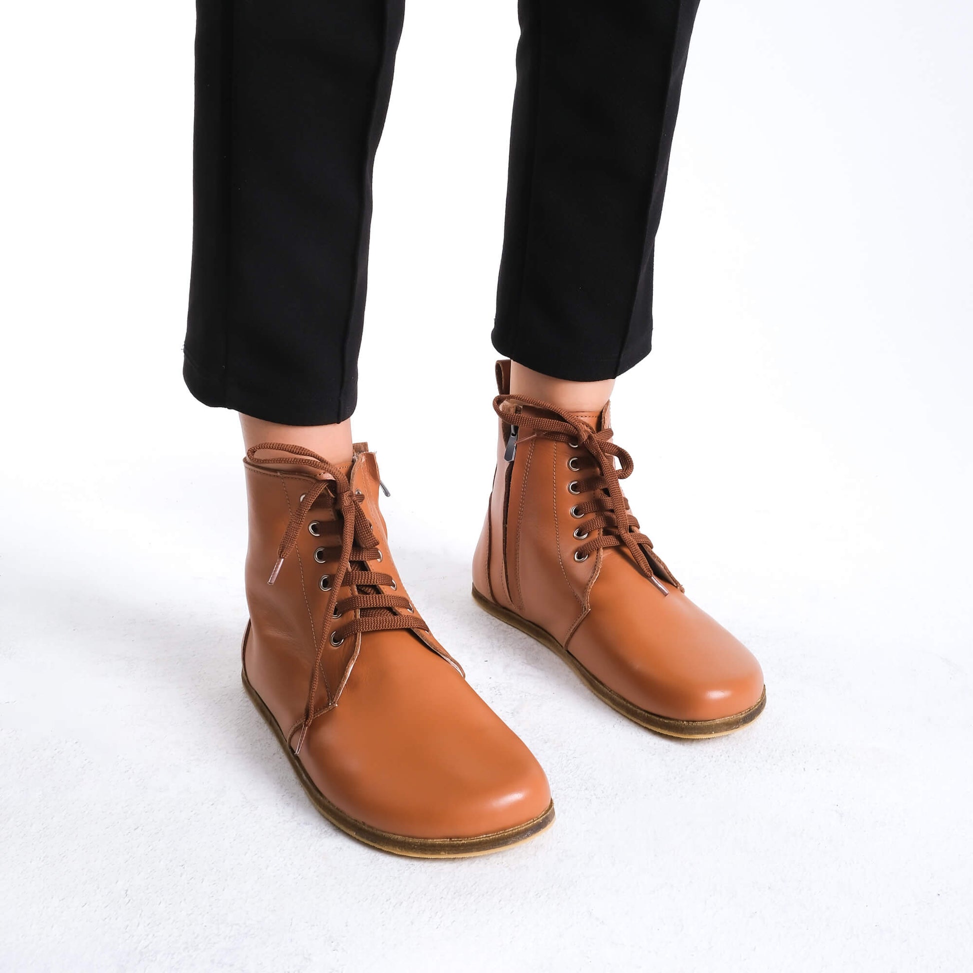 Premium tan brown leather barefoot boots showcasing a contemporary design for a polished look.