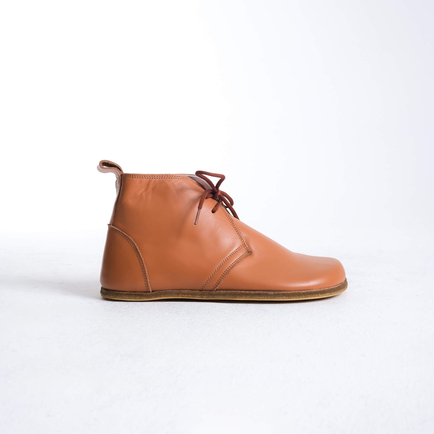 Trendy tan brown barefoot boots featuring a unique design for ultimate comfort.