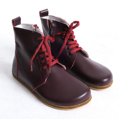 Stylish burgundy barefoot ankle boots with a sleek design and lace-up front, perfect for modern casual wear.