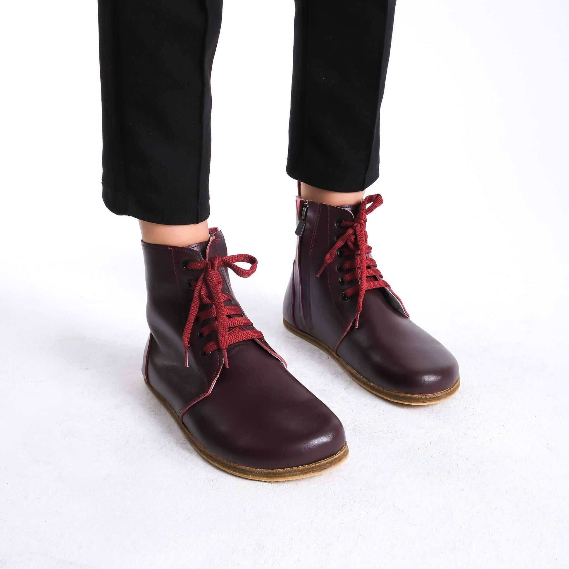 Premium burgundy leather barefoot boots showcasing a contemporary design for a polished look.