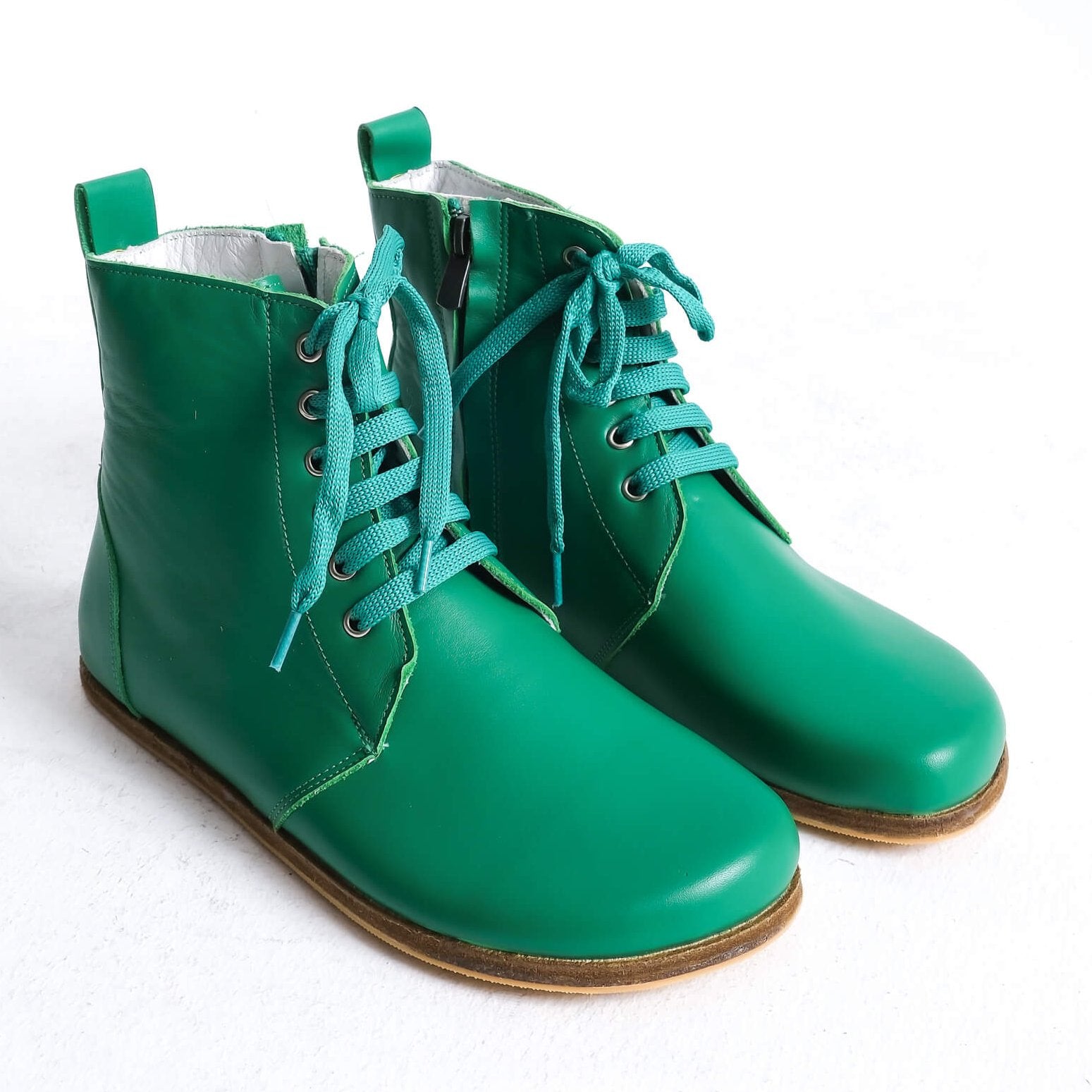 Stylish green barefoot ankle boots with a sleek design and lace-up front, perfect for modern casual wear.