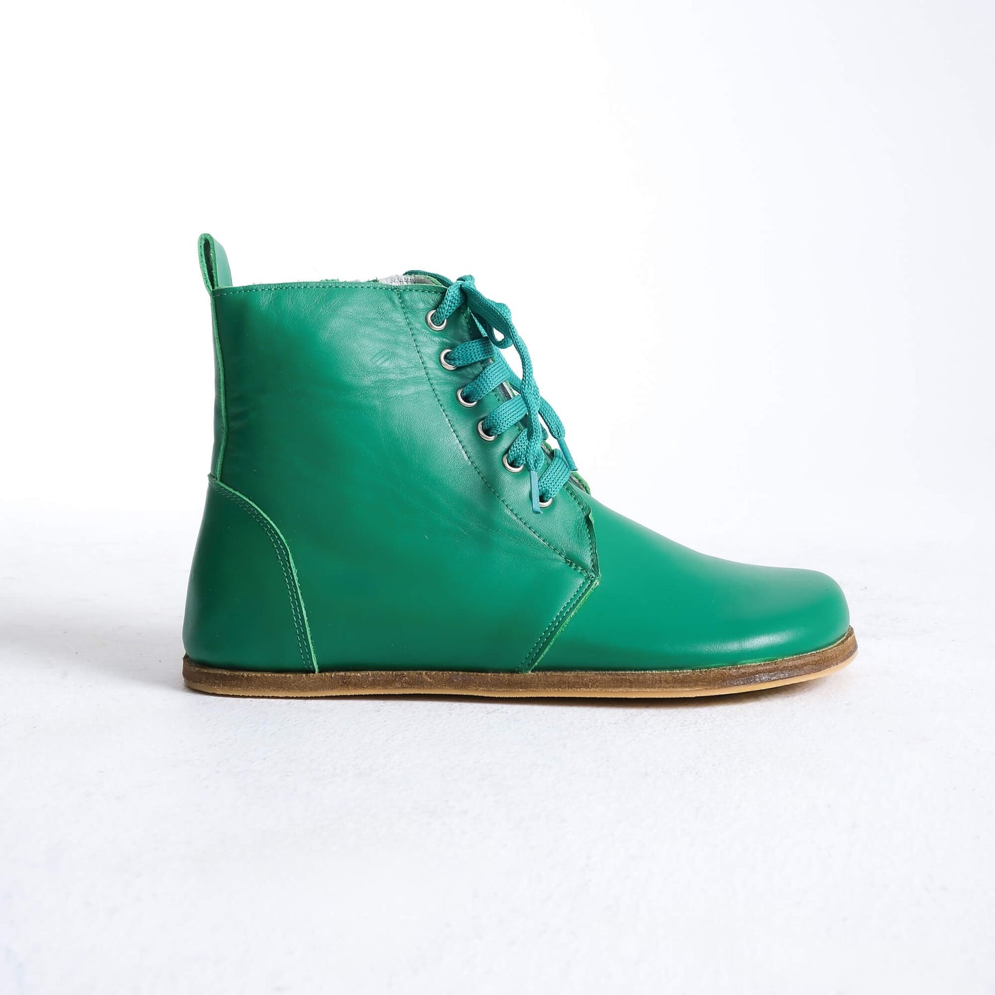 Versatile green barefoot boots featuring a unique design and sturdy construction for all-day wear.