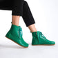 Chic green barefoot boots featuring a minimalist style, designed for comfort and flexibility.