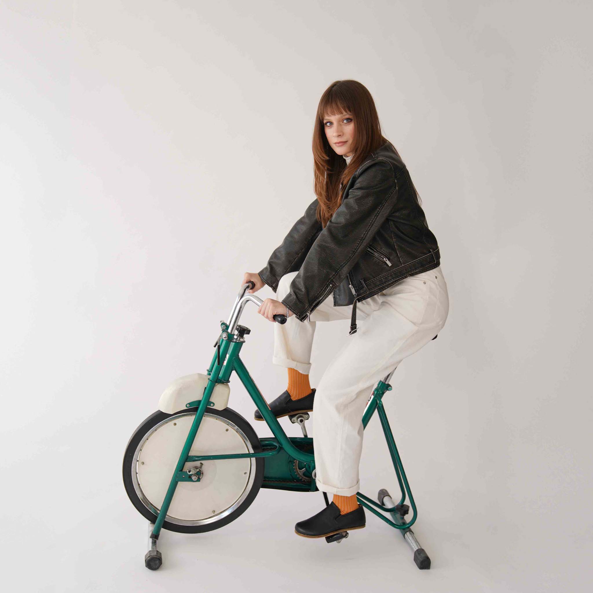 Woman Relaxing in Black Ionia Loafers on Exercise Bike