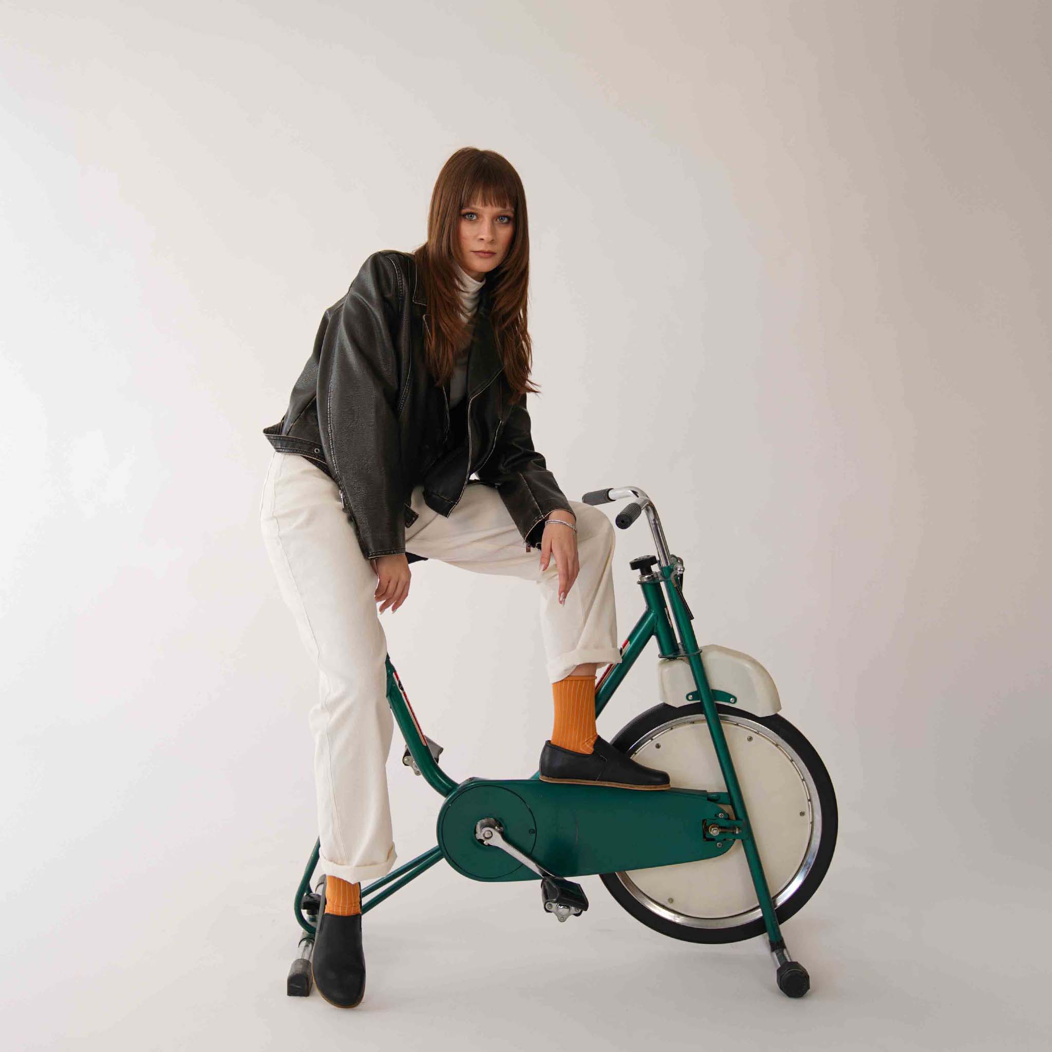 Woman in Black Ionia Loafers on Vintage Exercise Bike