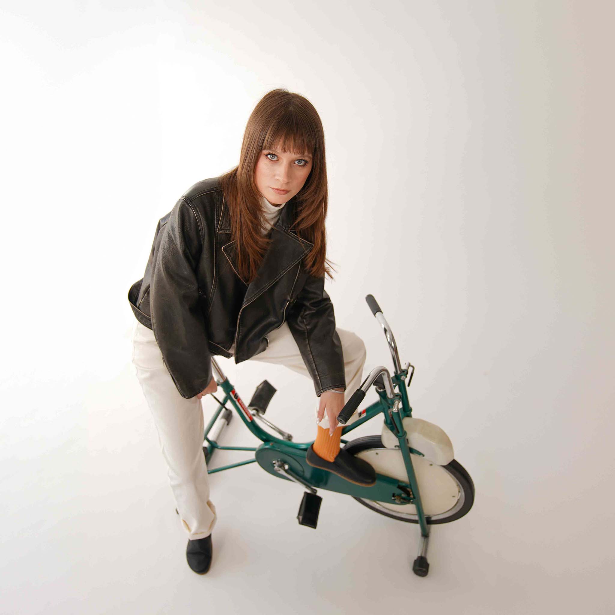 Stylish Woman with Black Loafers on Exercise Bike