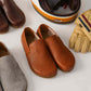Aeolia tan brown leather barefoot women loafers displayed with other leather loafers and accessories.