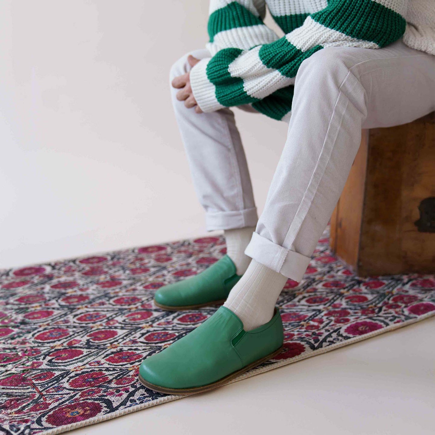 Man sitting with Green Ionia Leather Barefoot Men's Loafers, highlighting the natural fit and classic design. Discover more at pelanir.com!