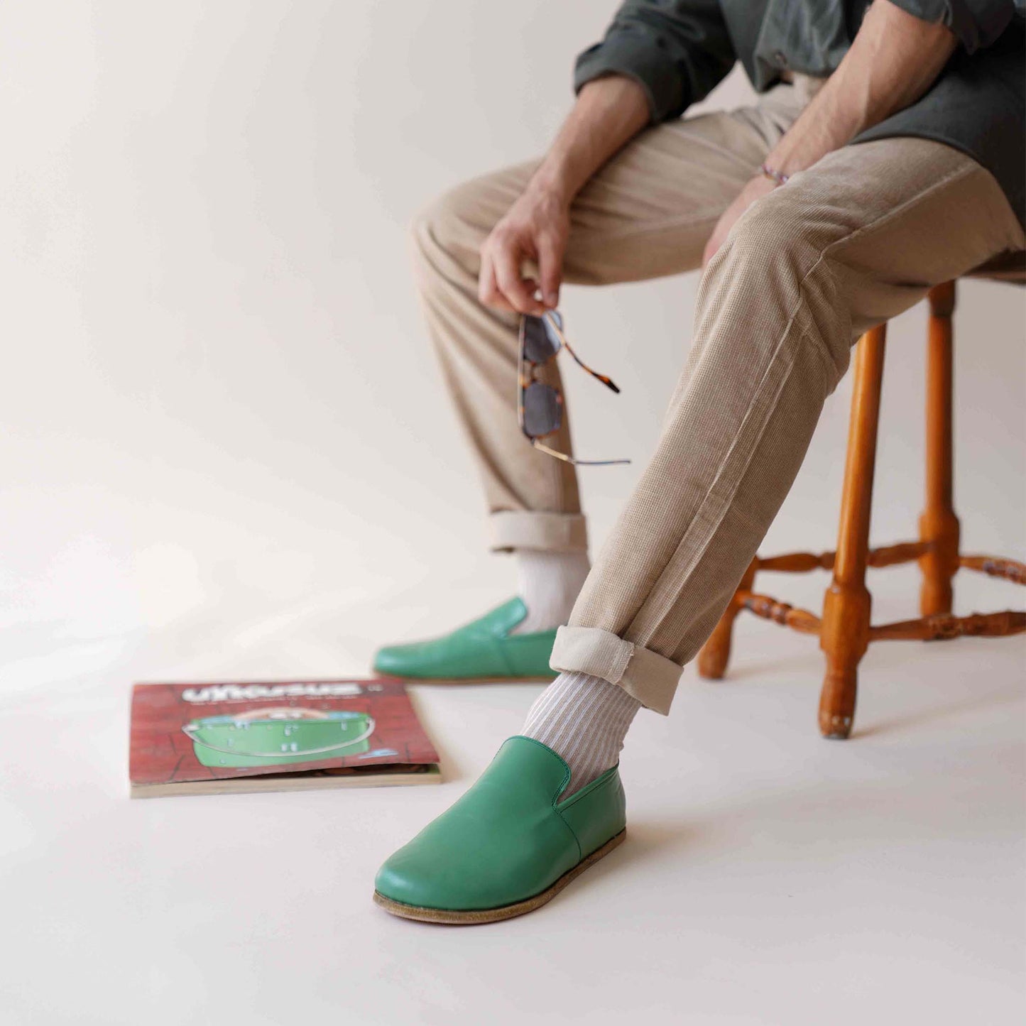 Relaxed style with Green Aeolia Leather Barefoot Men's Loafers, paired with beige pants and white socks for a casual and stylish look.