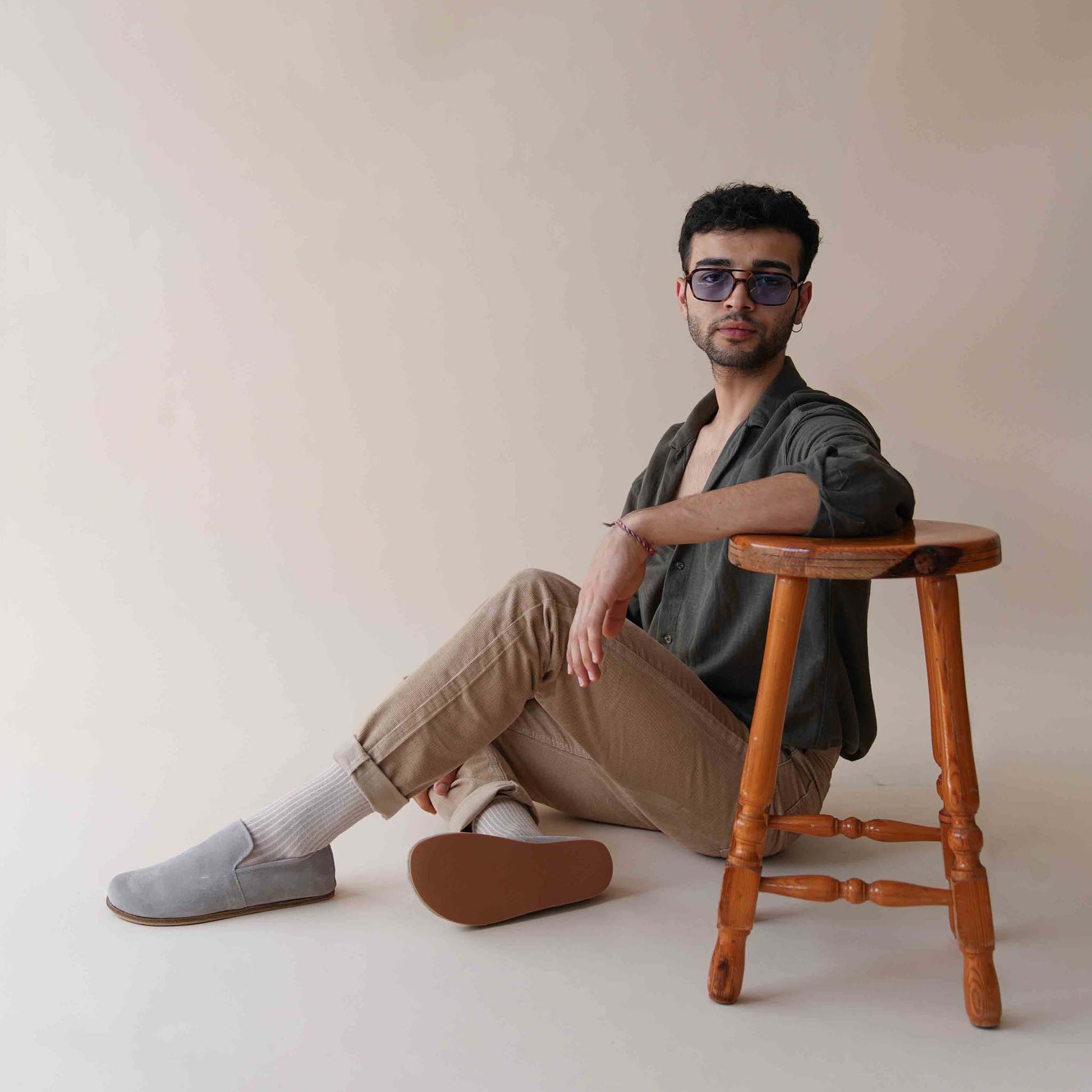 elaxed style with Gray suede Aeolia Leather Barefoot Men's Loafers, worn with beige pants and white socks, highlighting the casual elegance.