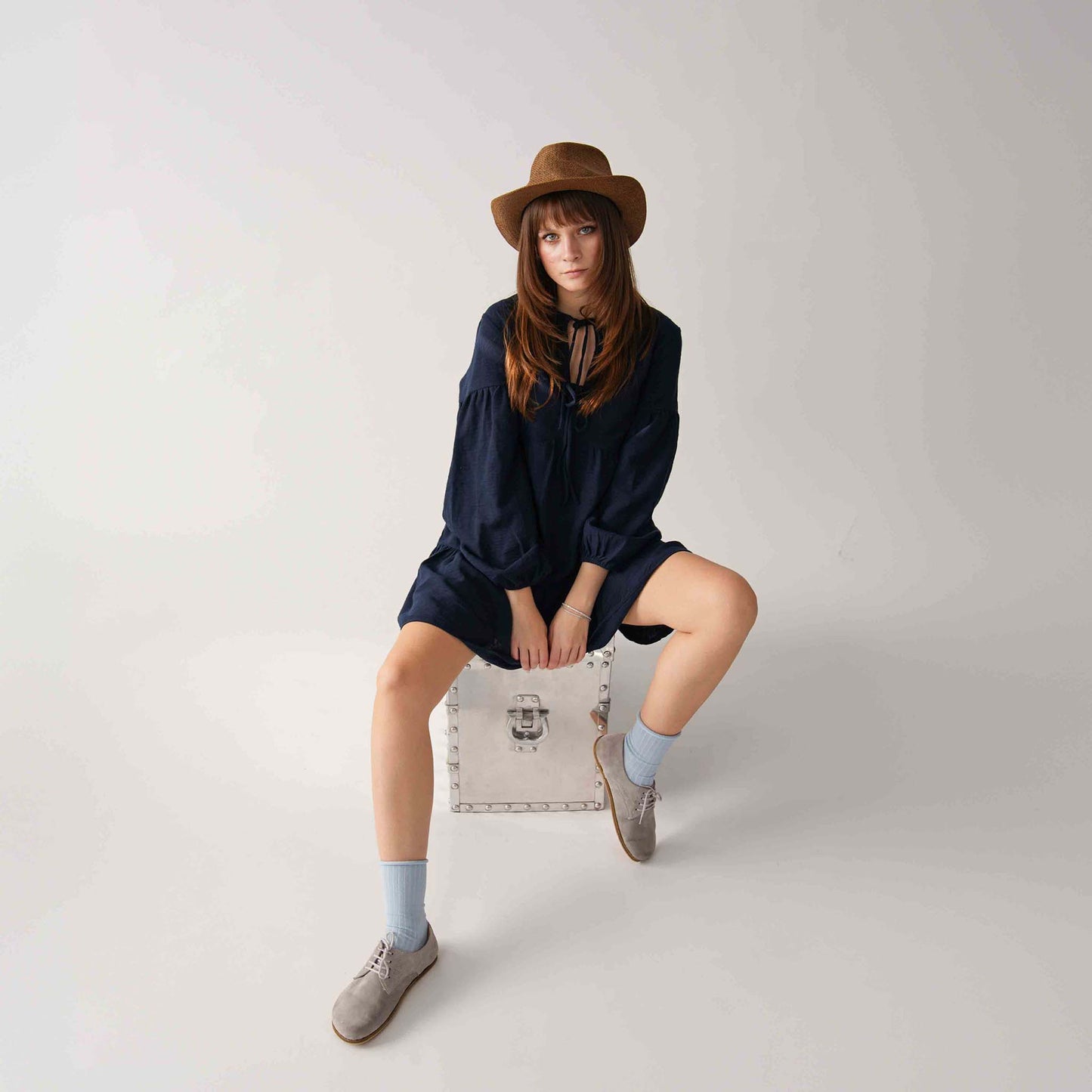 Fashion-forward look with gray suede Locris leather barefoot women oxfords, navy dress, and blue socks, perfect for any occasion.