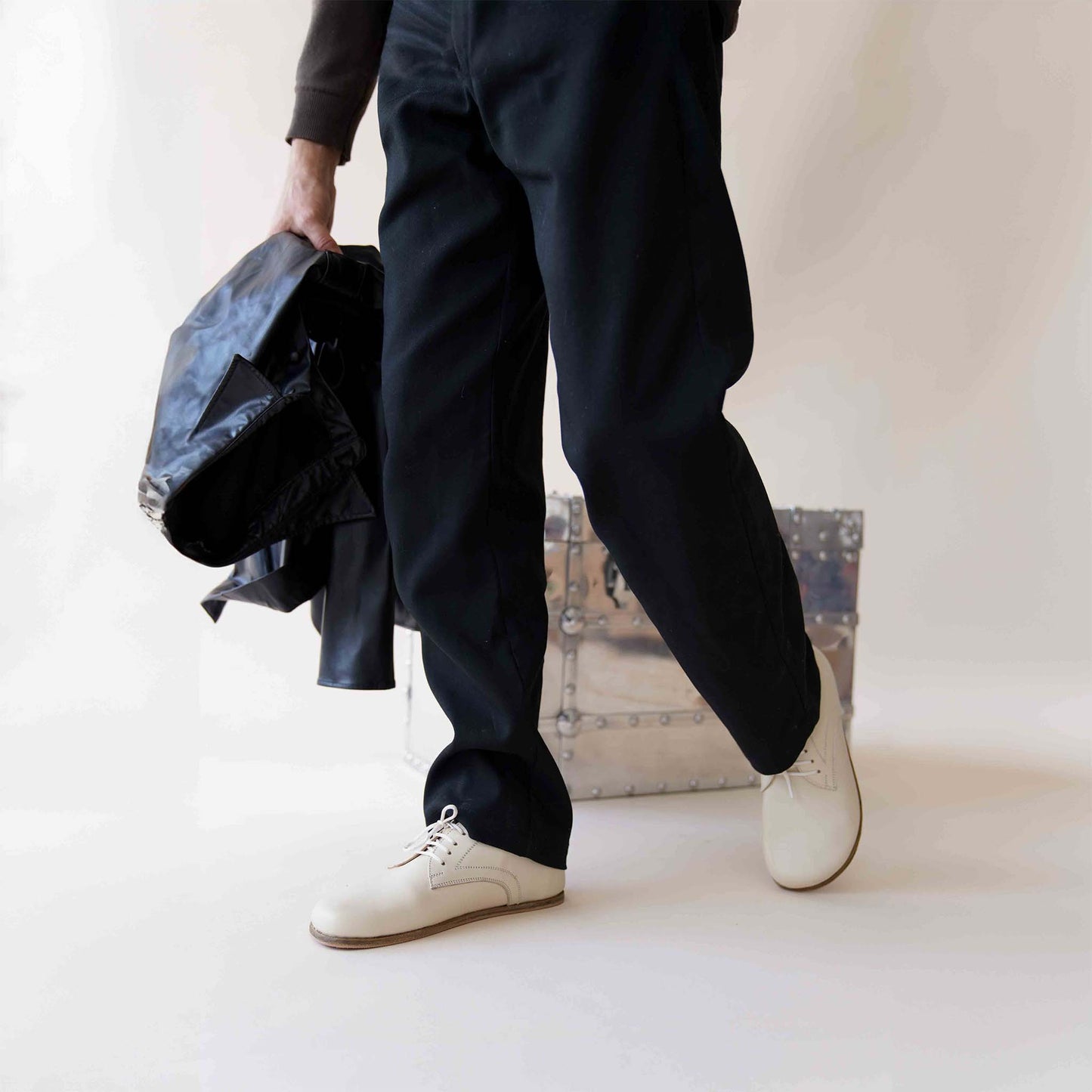 Man walking in beige Locris Leather Barefoot Oxfords, highlighting foot flexibility and comfort.