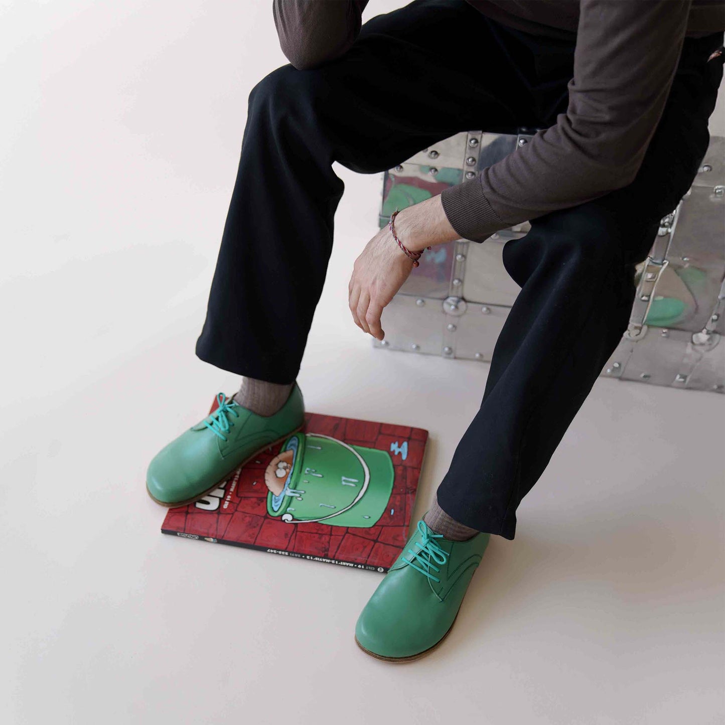 Top-down view of Locris Leather Barefoot Men's Oxfords in green, paired with gray socks, emphasizing their vibrant look.