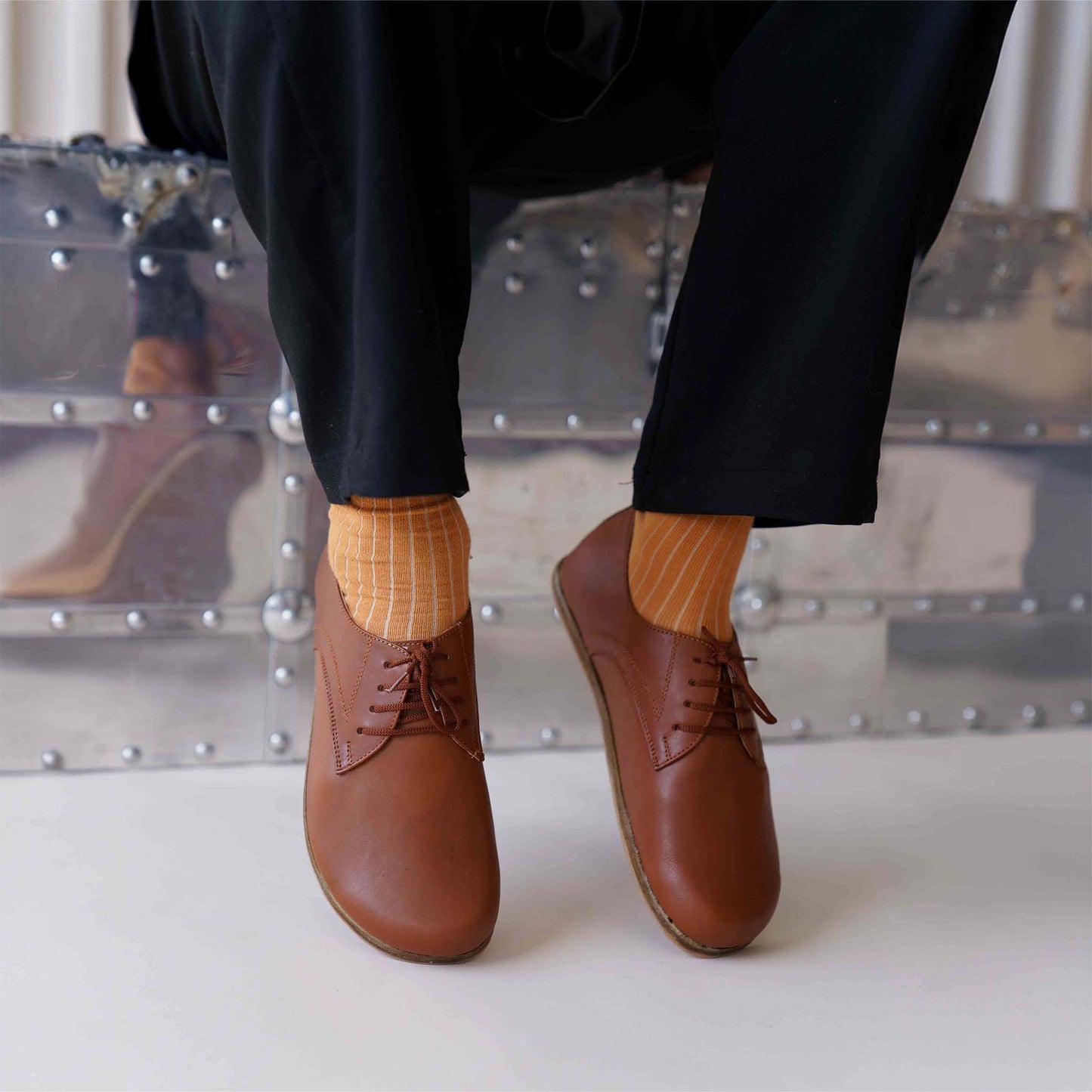 Top-down view of Locris Leather Barefoot Men's Oxfords in tan brown, paired with orange socks, emphasizing their unique style.