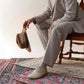 Stylish man wearing beige Doris Leather Barefoot Men's Oxfords with a hat, ideal for formal and casual outfits.