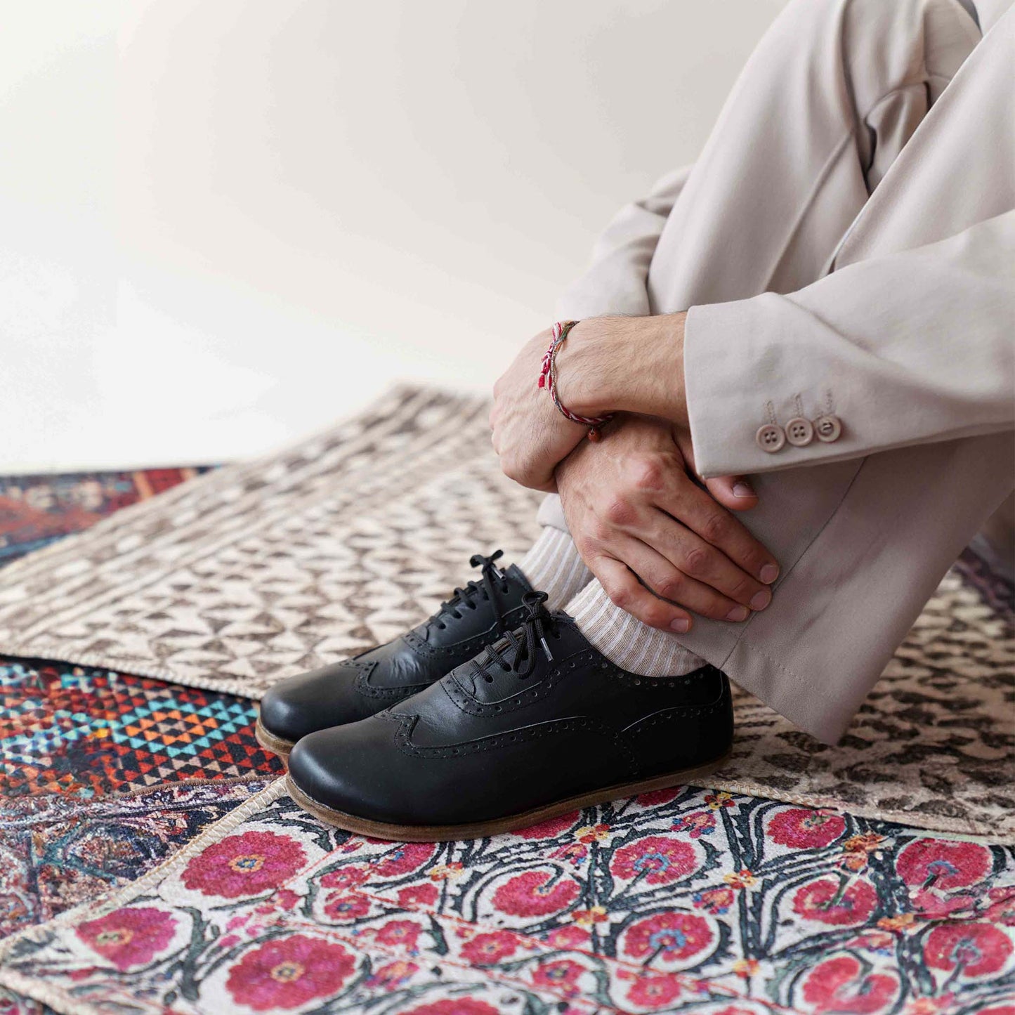 Man wearing black Doris Leather Barefoot Men's Oxfords, featuring a stylish and comfortable look.