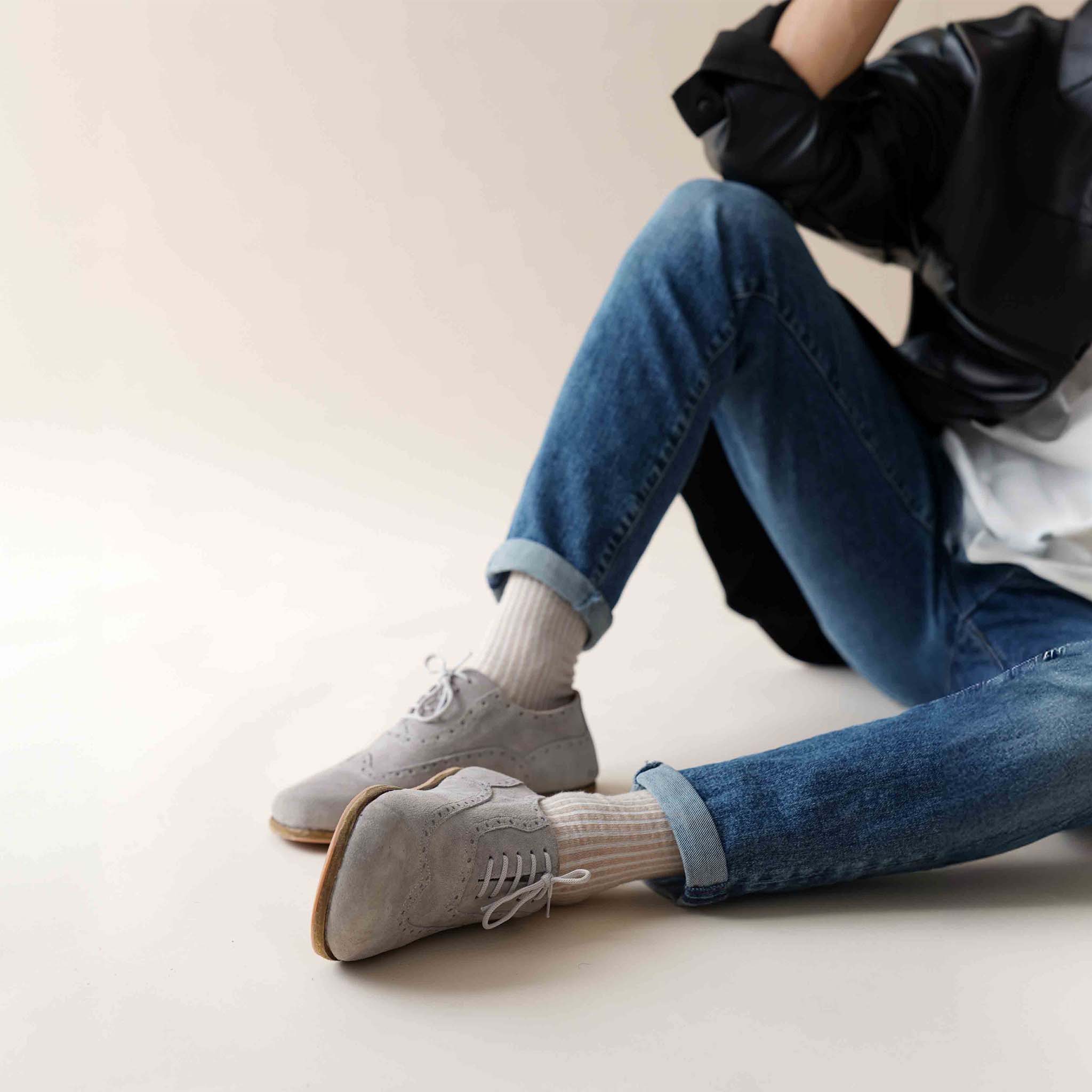 Stylish gray suede barefoot Oxfords paired with jeans – modern, versatile, and comfortable footwear.