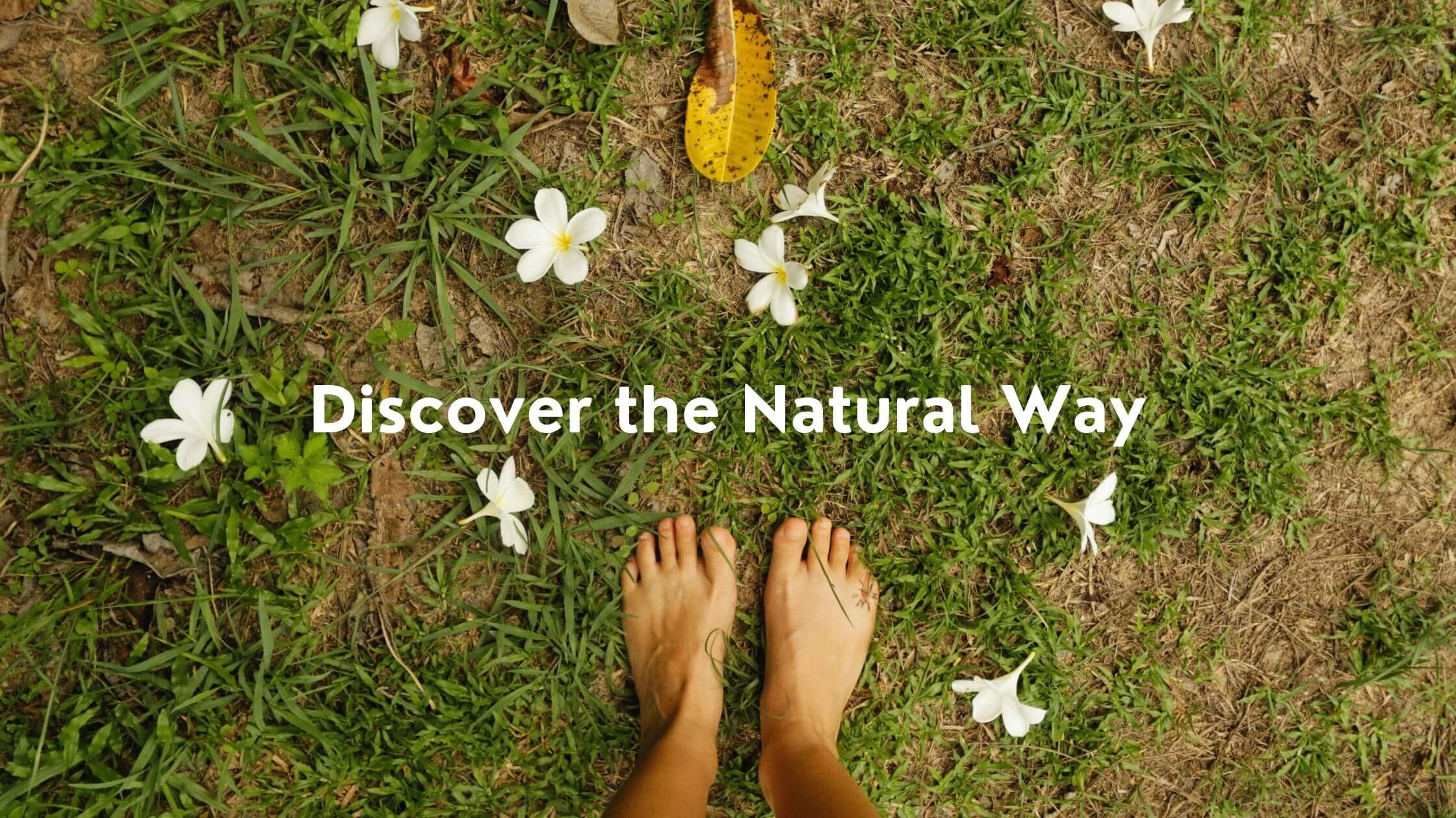 Bare feet on grass with white flowers, text 'Discover the Natural Way'.